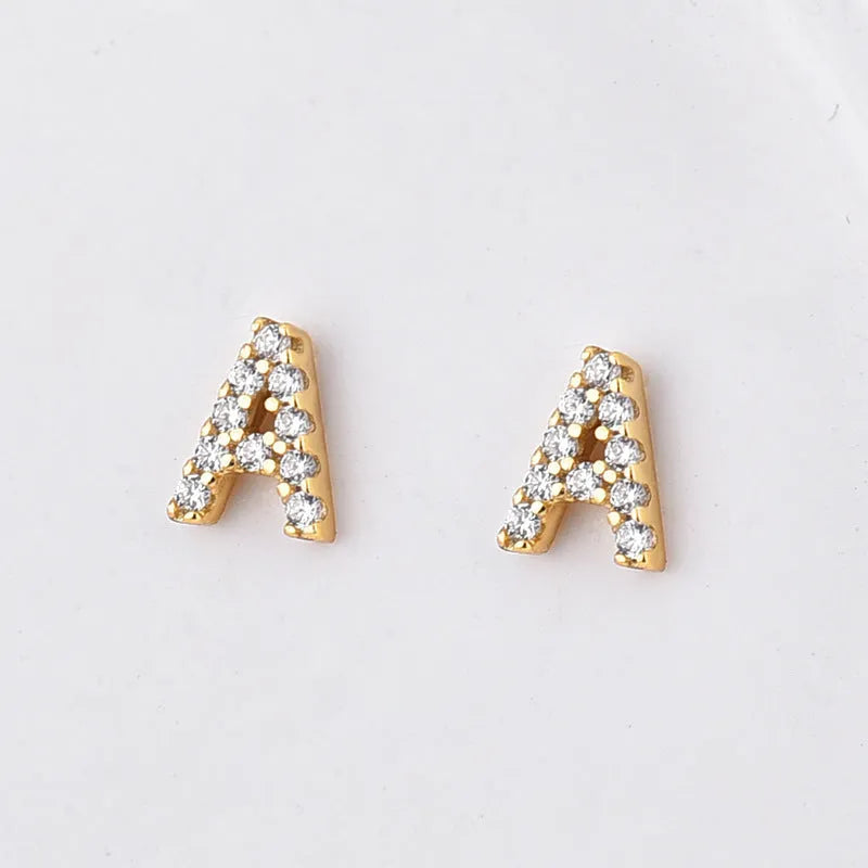A single gold plated earring shaped like the letter A, set with small sparkling zircon stones.