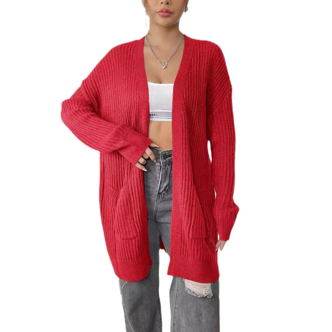 Women's dark green acrylic cardigan with two front pockets and long sleeves on a hanger.