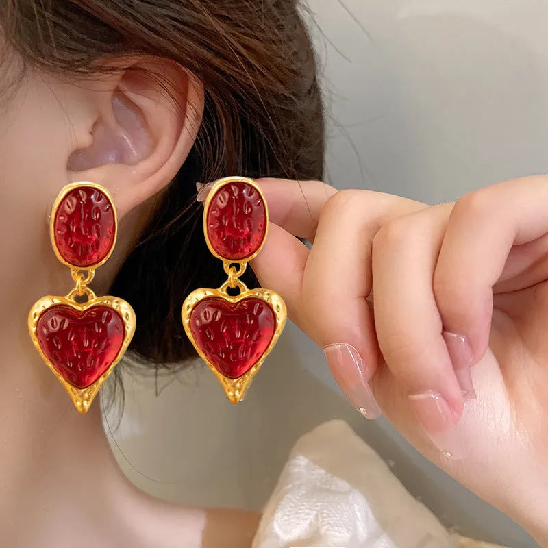 Silver pleated heart-shaped stud earrings in purple, red, green, and yellow/white colours.