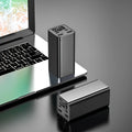 High power laptop charging bank with metal casing showing black, blue, and grey colour options