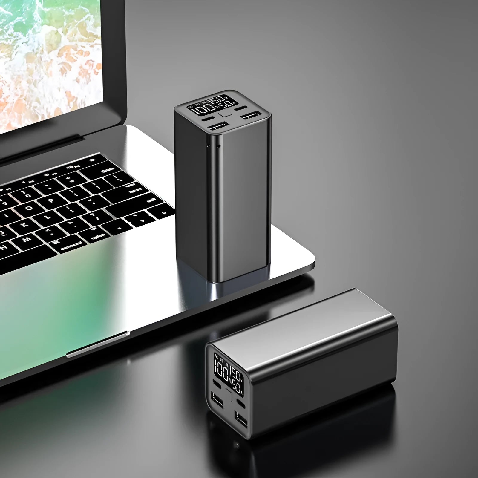 High power laptop charging bank with metal casing showing black, blue, and grey colour options