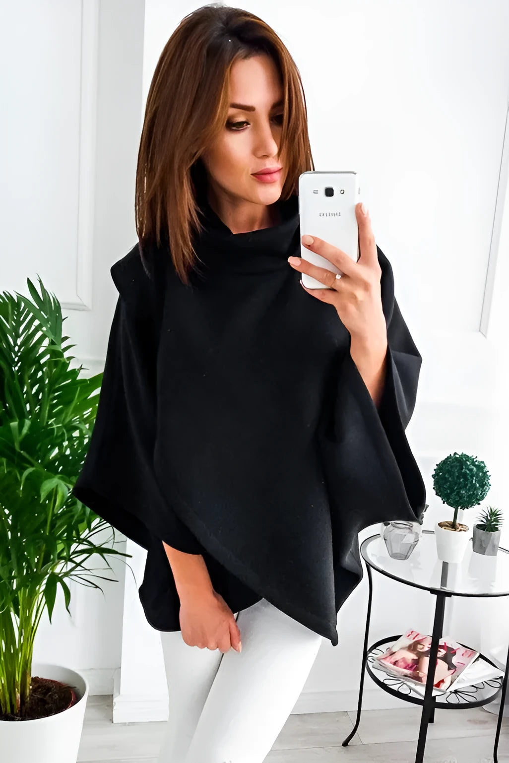 Long black women's cardigan sweatshirt with batwing sleeves and decorative stitching, shown open over a top.