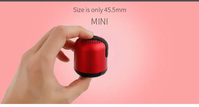 Hieha XQ11 cylindrical mini portable Bluetooth speaker in silver colour on a table.