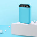 Compact mini power bank in black, blue, pink or white with dimensions 93mm by 63mm by 22mm