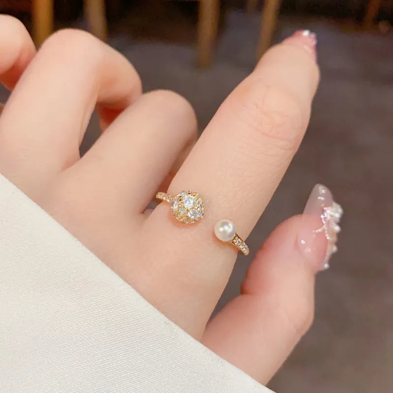Open-end pearl ring with round zircon decoration in gold or silver colour with thick real gold plating