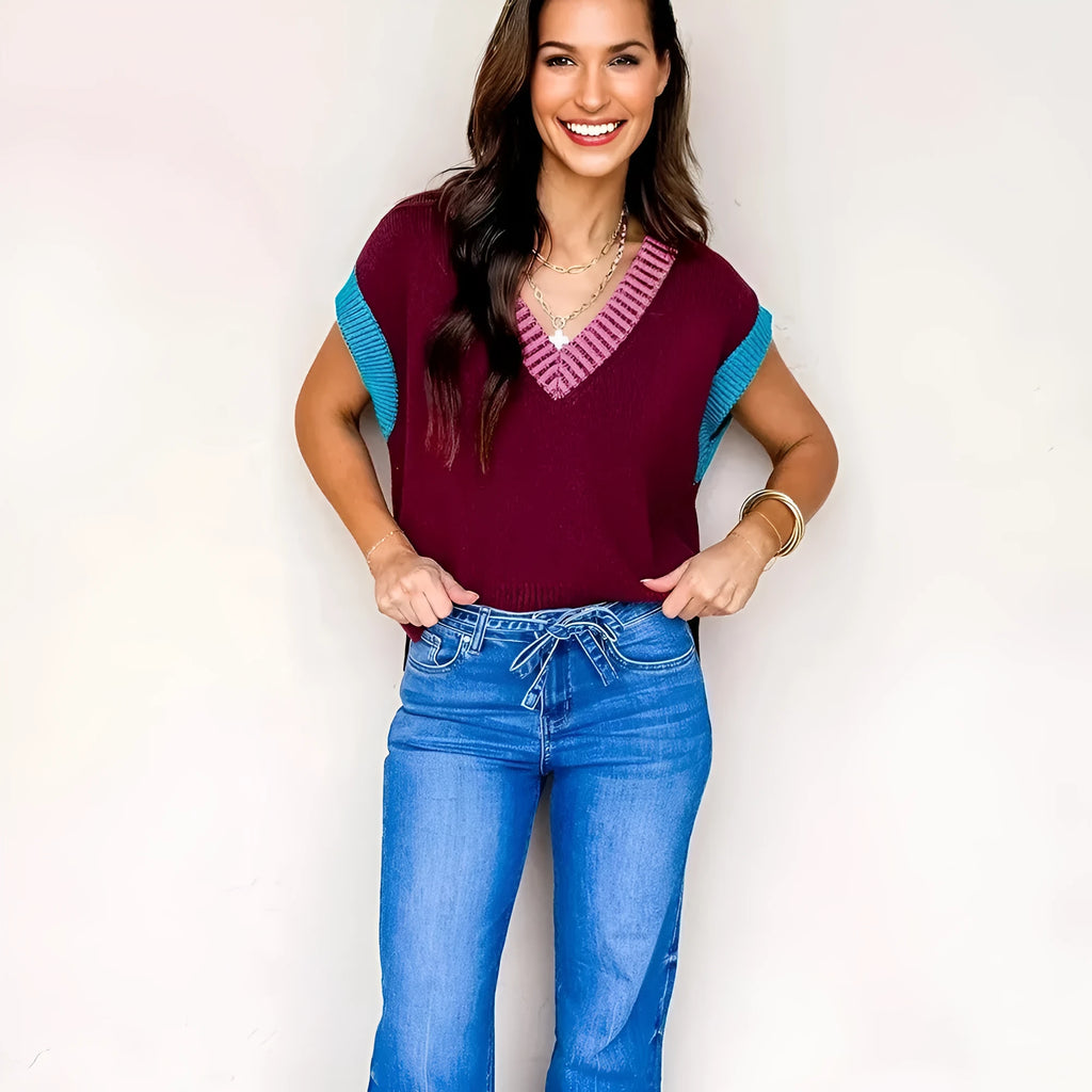 Burgundy loose-fitting V-neck sweater with contrast trim detail on cuffed short sleeves.