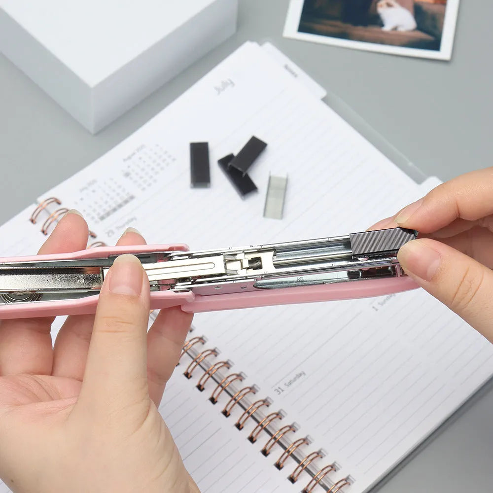Box of 1000 metal office staples in rose gold, black, purple, and rose red colours.