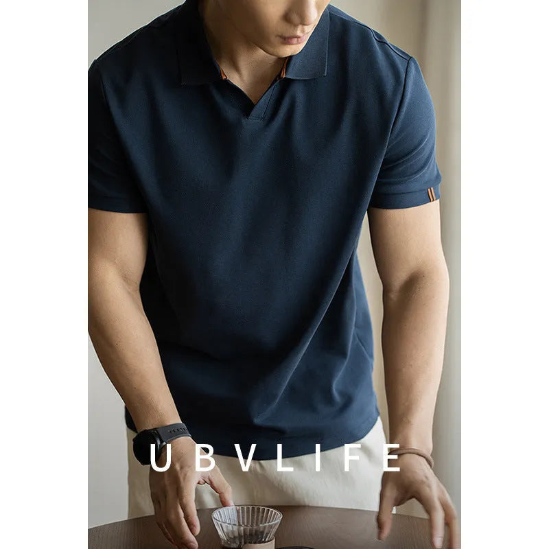 Man's short-sleeve blue polo shirt on a hanger, showing the classic collar and button placket.