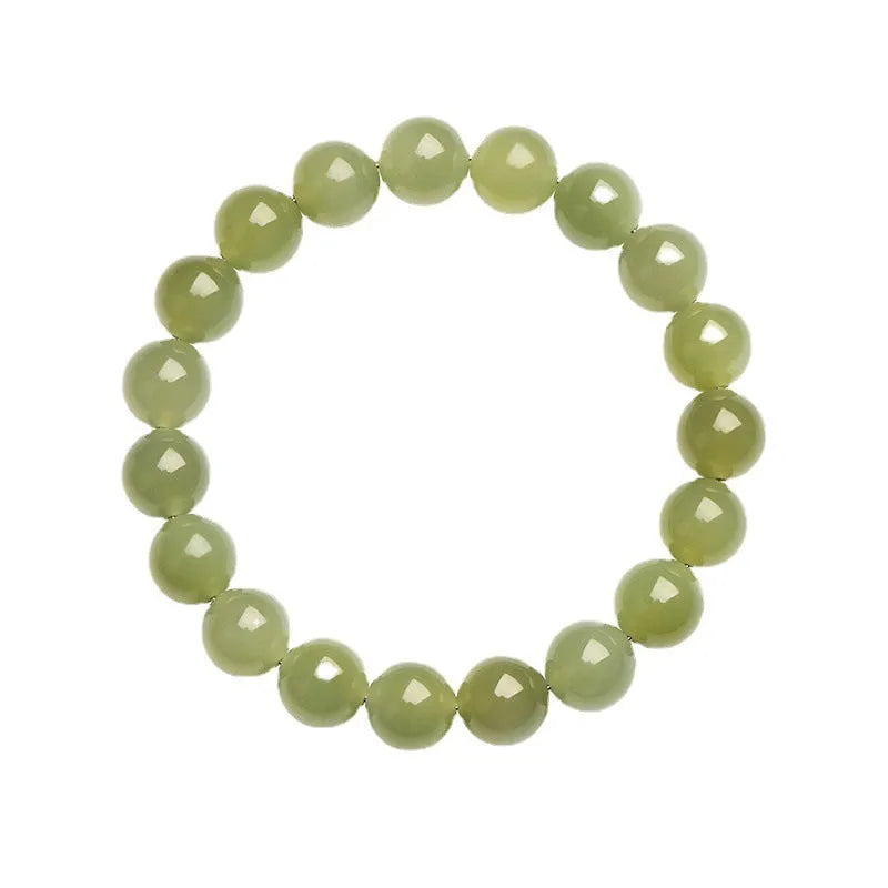 Hetian jade ball bracelet on wrist showing polished spherical beads on an elasticated string in a clear colour.