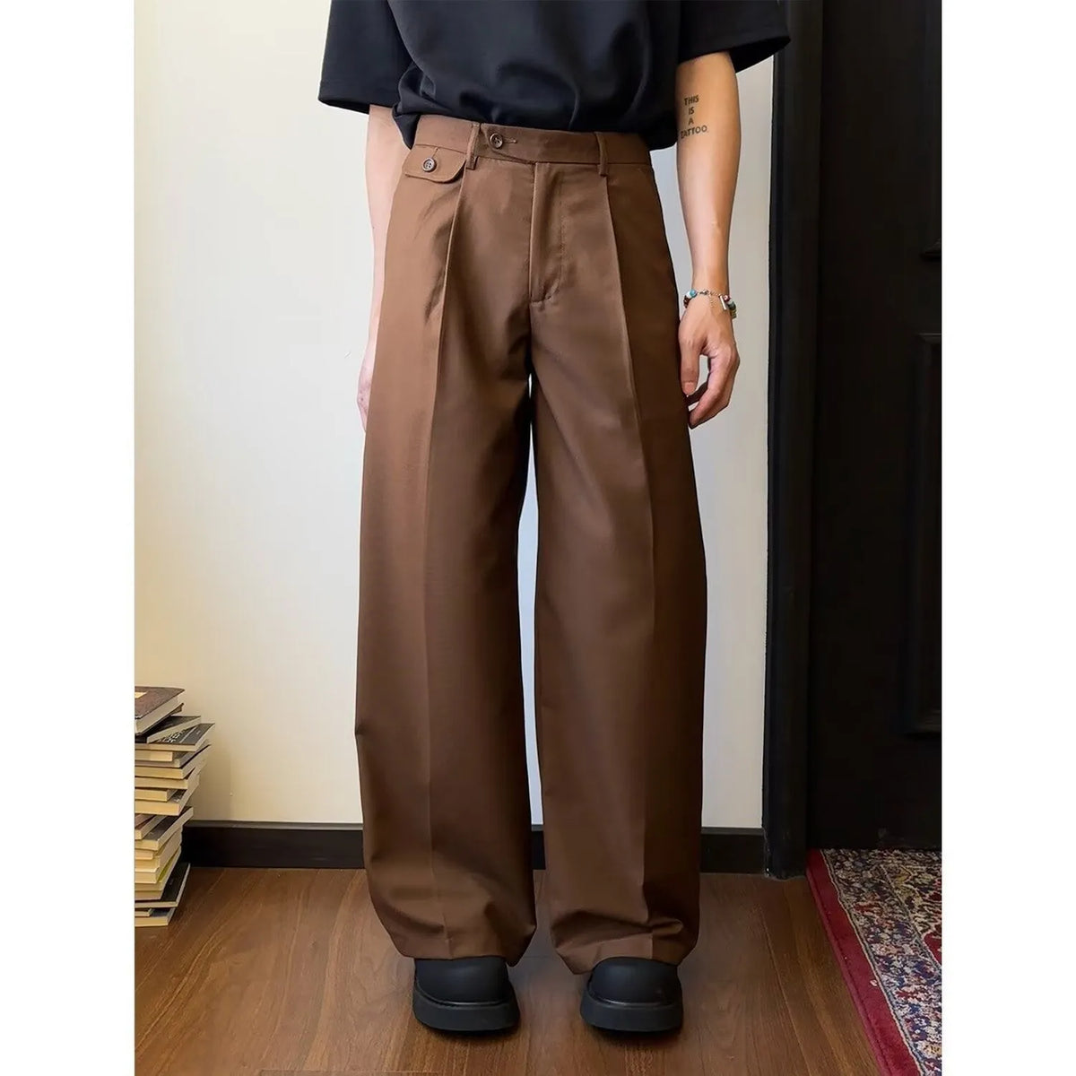 Brown men's straight-leg loose-fit suit trousers laid flat, showing wide-leg drape style.