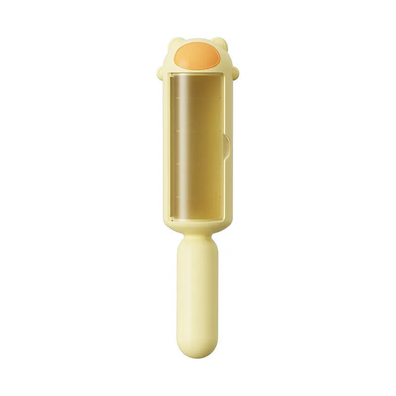 Blue reusable pet hair remover tool with self-cleaning base on a fabric sofa.