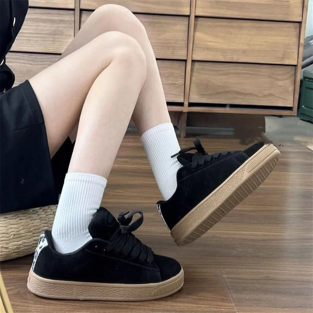 Black retro low-top sneakers with round toe design and waterproof platform construction