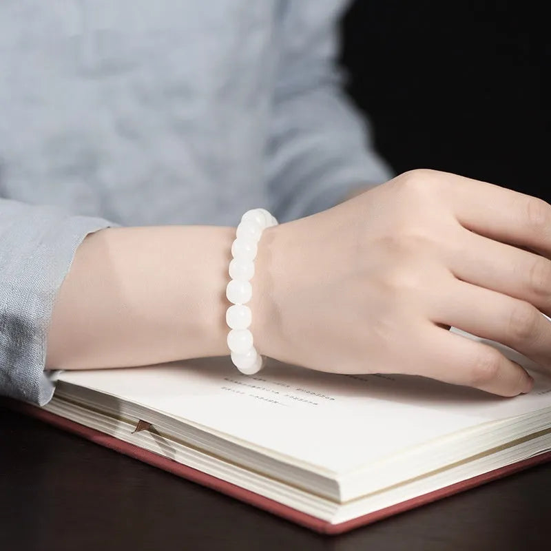 White Hetian jade barrel bead bracelet showing three size options on a neutral background