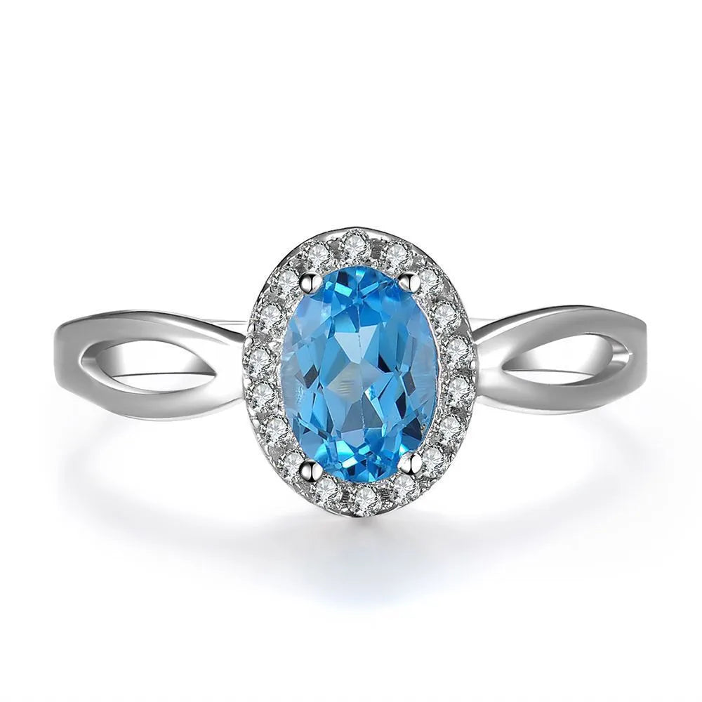 925 sterling silver jewellery set with blue topaz gems showing earrings, ring, pendant and necklace with geometric design