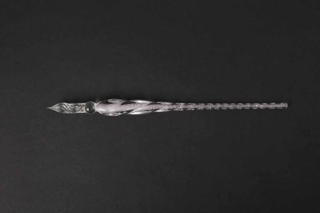 Transparent glass crystal pen with coloured ink visible inside, abstract modelling design