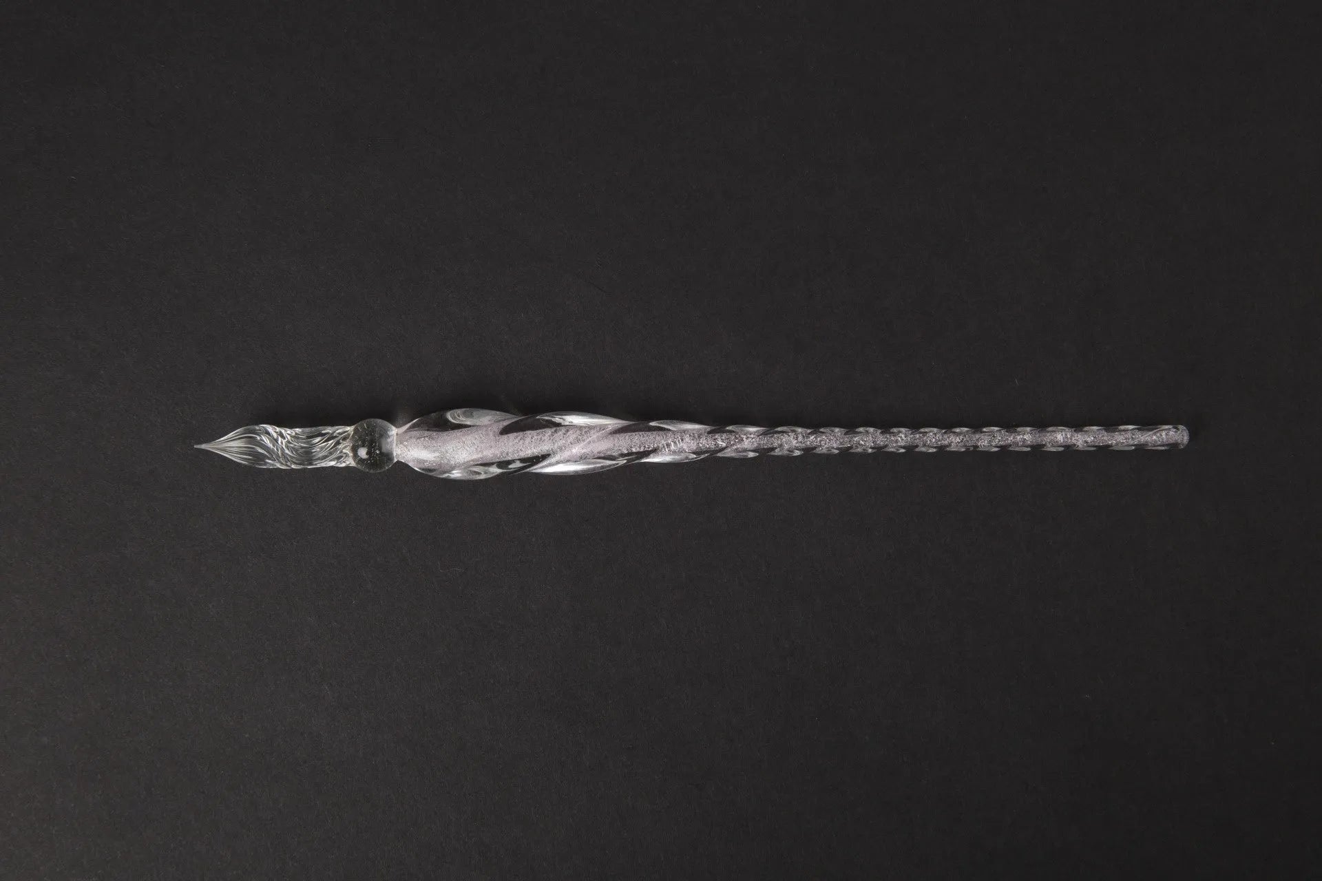 Transparent glass crystal pen with coloured ink visible inside, abstract modelling design