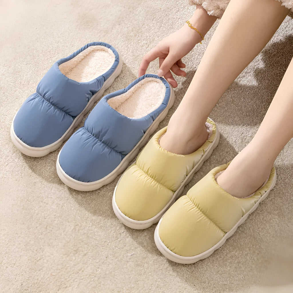 A pair of down cotton slippers with an artificial leather upper and thick rubber sole, shown in blue.