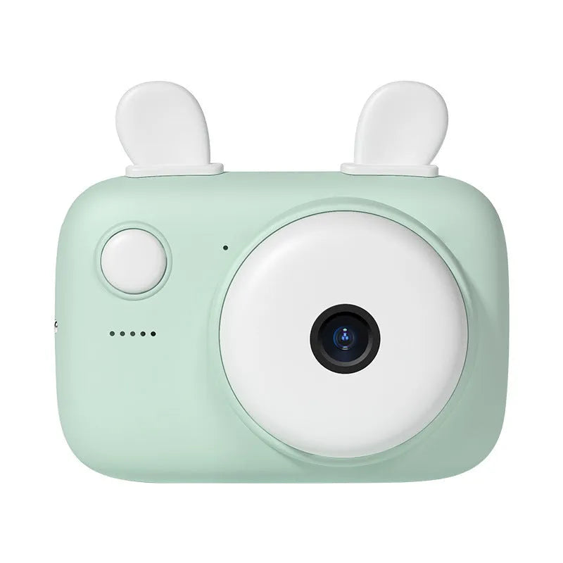 A2 Kids Macaron digital camera in green, showing front and rear lenses and 2.4-inch screen, with lanyard attached.
