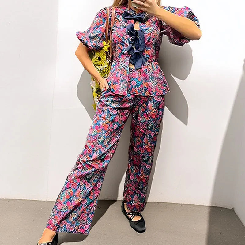 Floral printed two-piece trouser suit with puff sleeves and tie-neck detail in picture colour