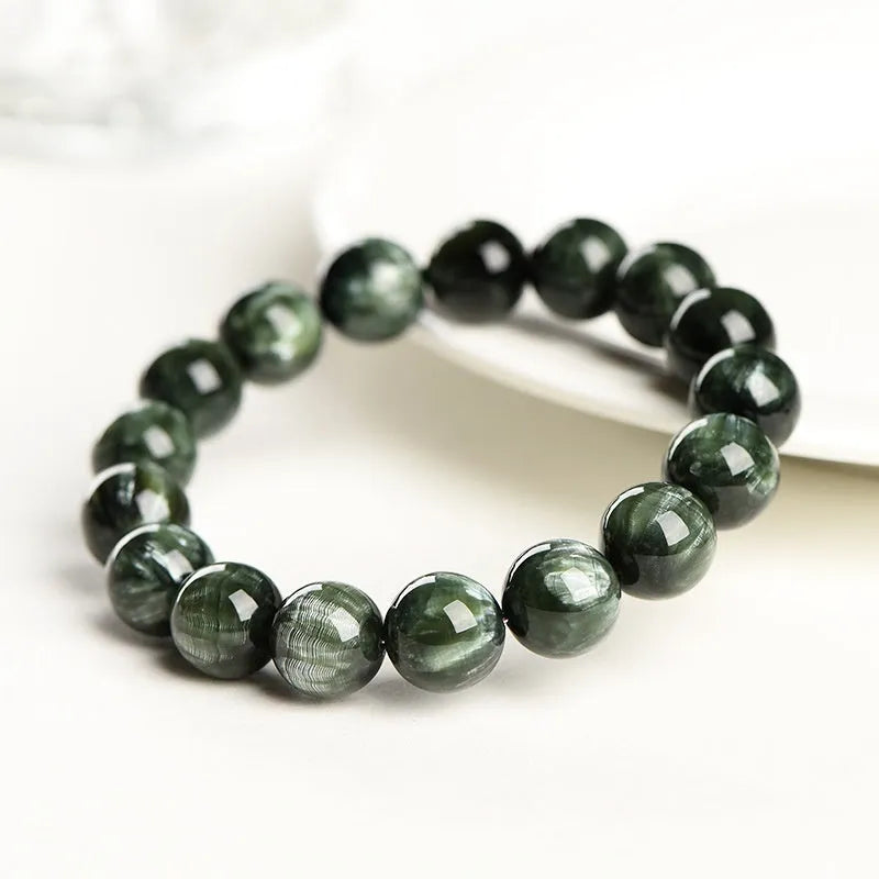 Green dragon crystal bracelet with geometric round beads showing ruyi symbolism detail