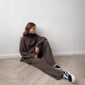 Women's dark grey acrylic sweater suit with side slits and matching trousers