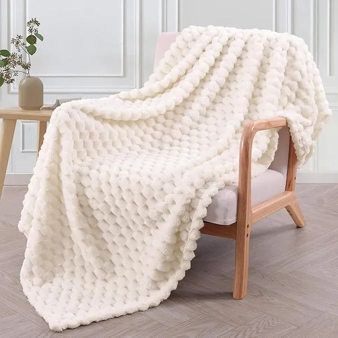 Children's soft plaid polyester blanket in camel colour on a bed