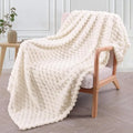 Children's soft plaid polyester blanket in camel colour on a bed