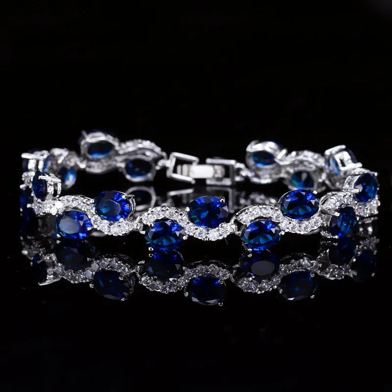 Copper gold plated women's bracelet with white gold colour finish and inlaid AAA zircon stones on a geometric band.