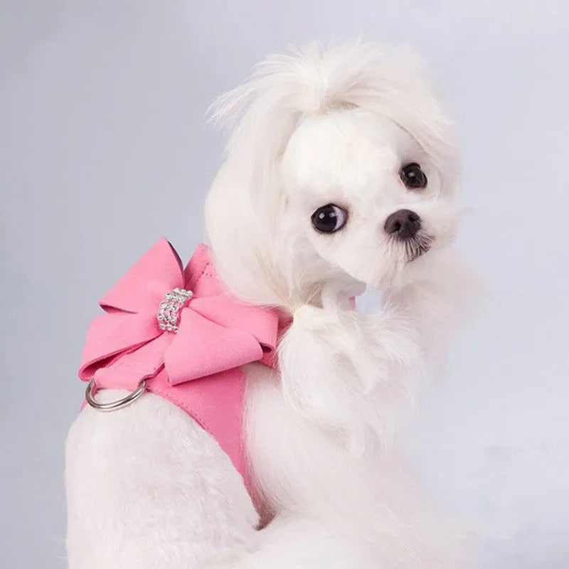 A pink microfiber dog chest strap featuring a sewn-on bowknot shaped like a puppy.