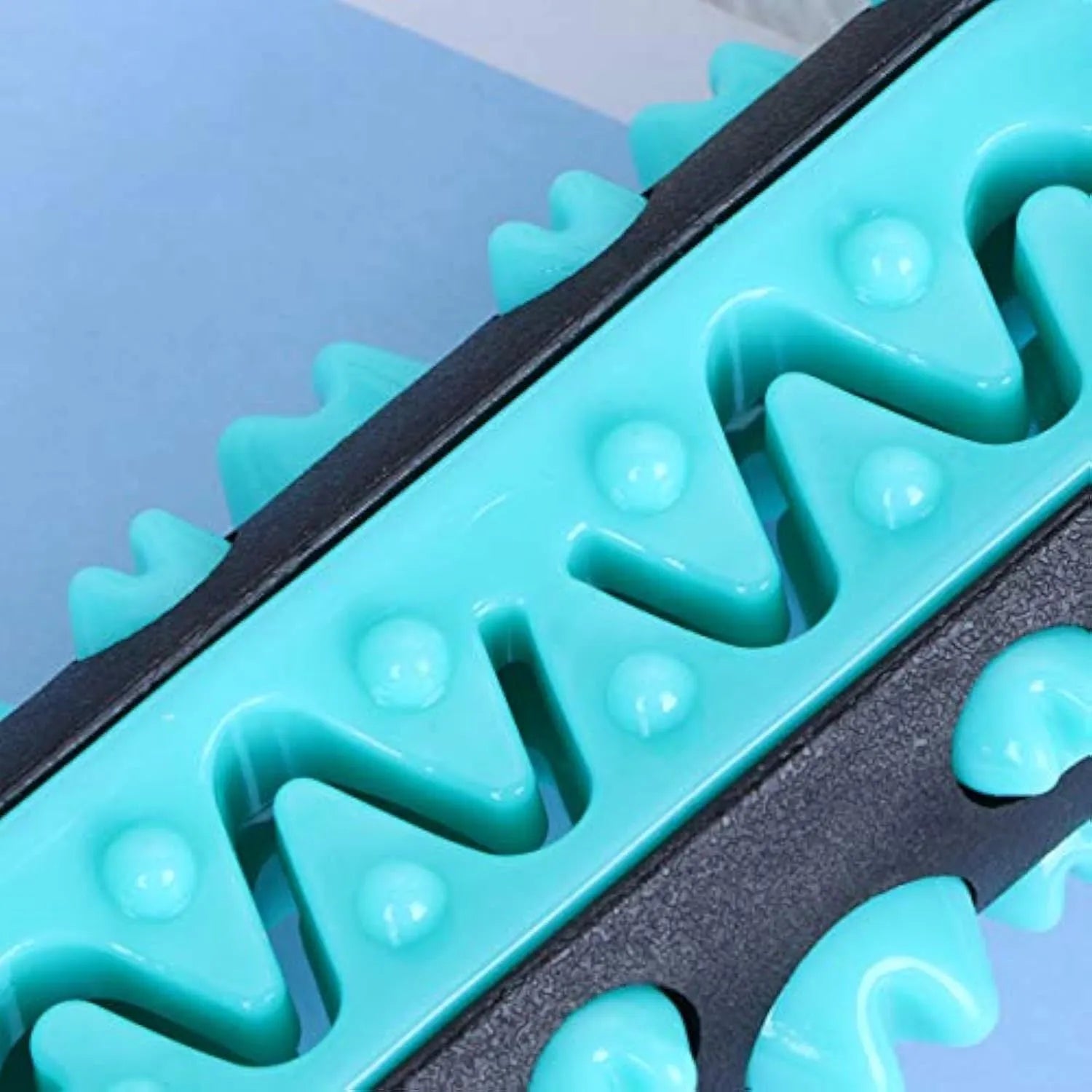 Natural rubber dog toothbrush chew toy in blue colour showing textured dental cleaning surface
