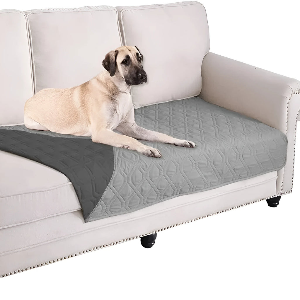 Reversible waterproof dog blanket on sofa showing two colour options with multiple size measurements