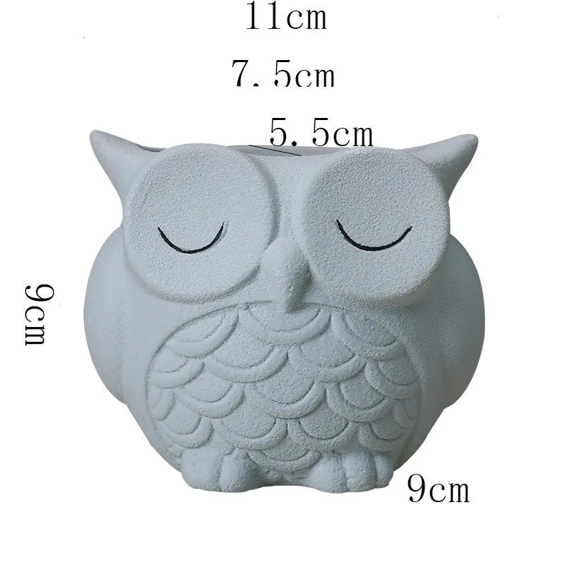 Handmade ceramic owl-design succulent pot in frosted light pink, white, green, or blue, measuring 11cm by 9cm.