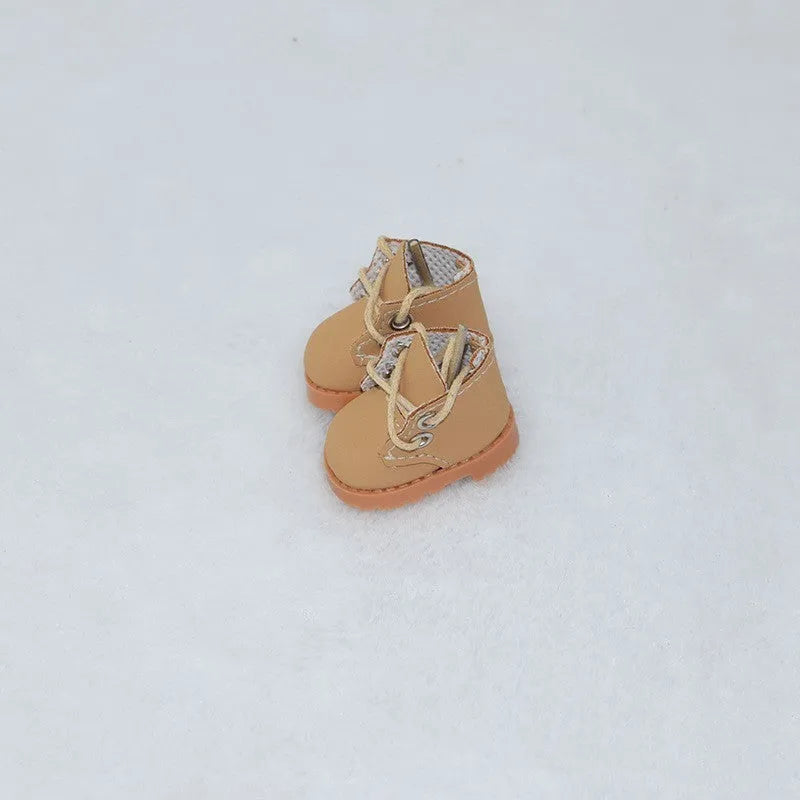 A pair of 17cm high PU replacement shoes for dolls in a selected style and colour.