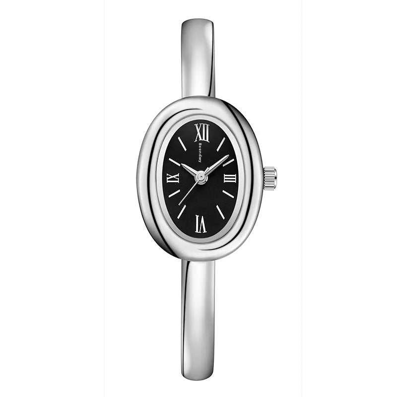 Women's oval retro quartz watch in gold colour with spiral pattern on dial.