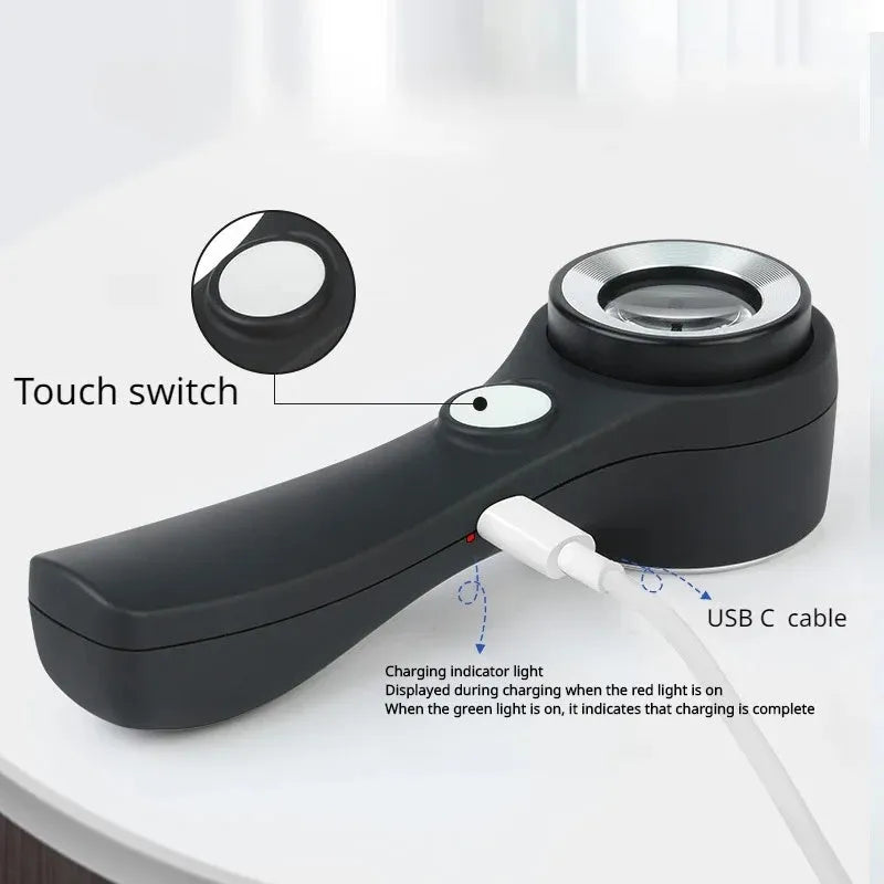 Black handheld magnifying glass with USB-C cable for charging its built-in inspection light.