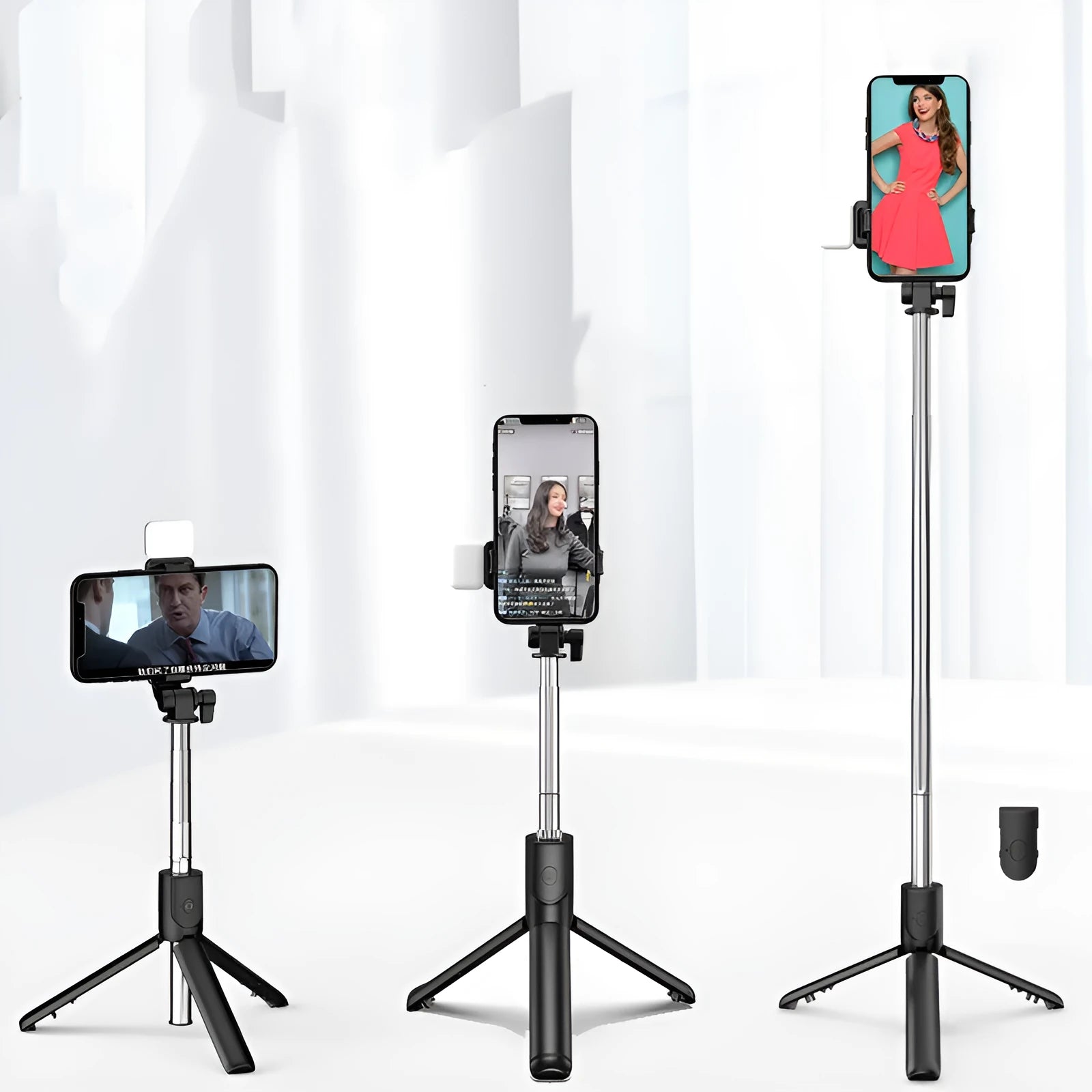 Black Bluetooth selfie stick with tripod base and phone holder, shown extended, for use with Apple iPhones.