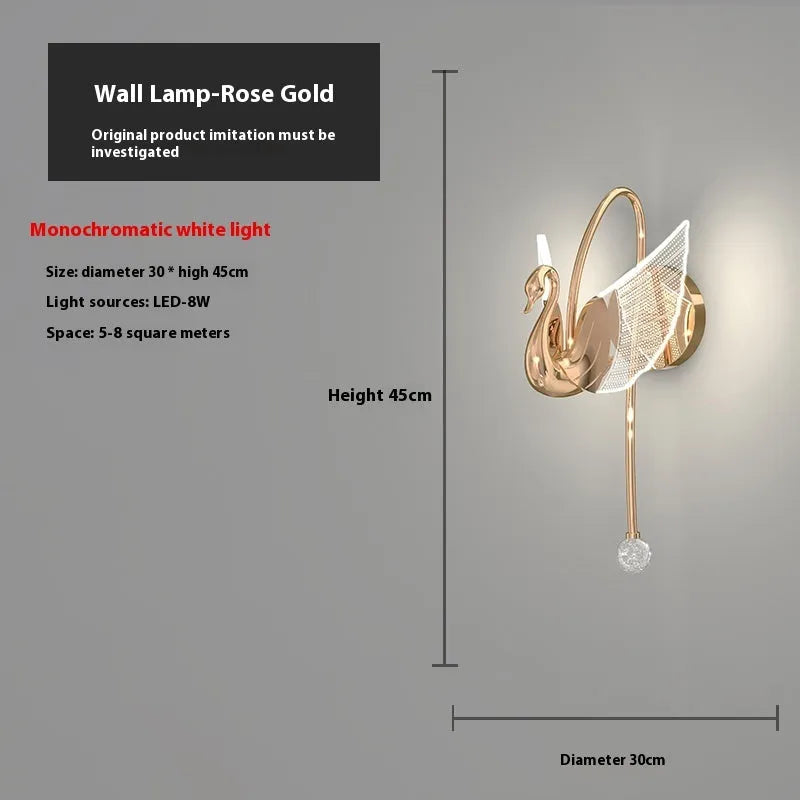 Gold modern swan wall lamp with acrylic shade mounted beside bed