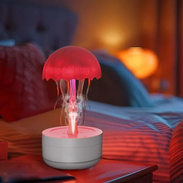 White jellyfish-shaped humidifier and essential oil diffuser with colourful LED lights on a desk.