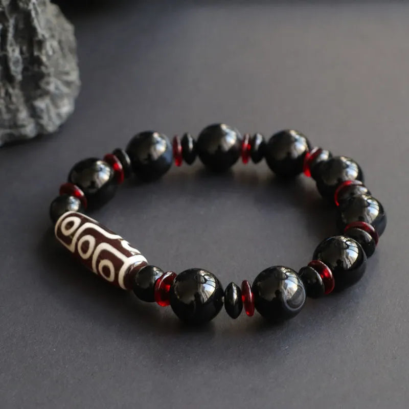 Black agate dzi bead bracelet with hand-woven construction and 11mm geometry beads