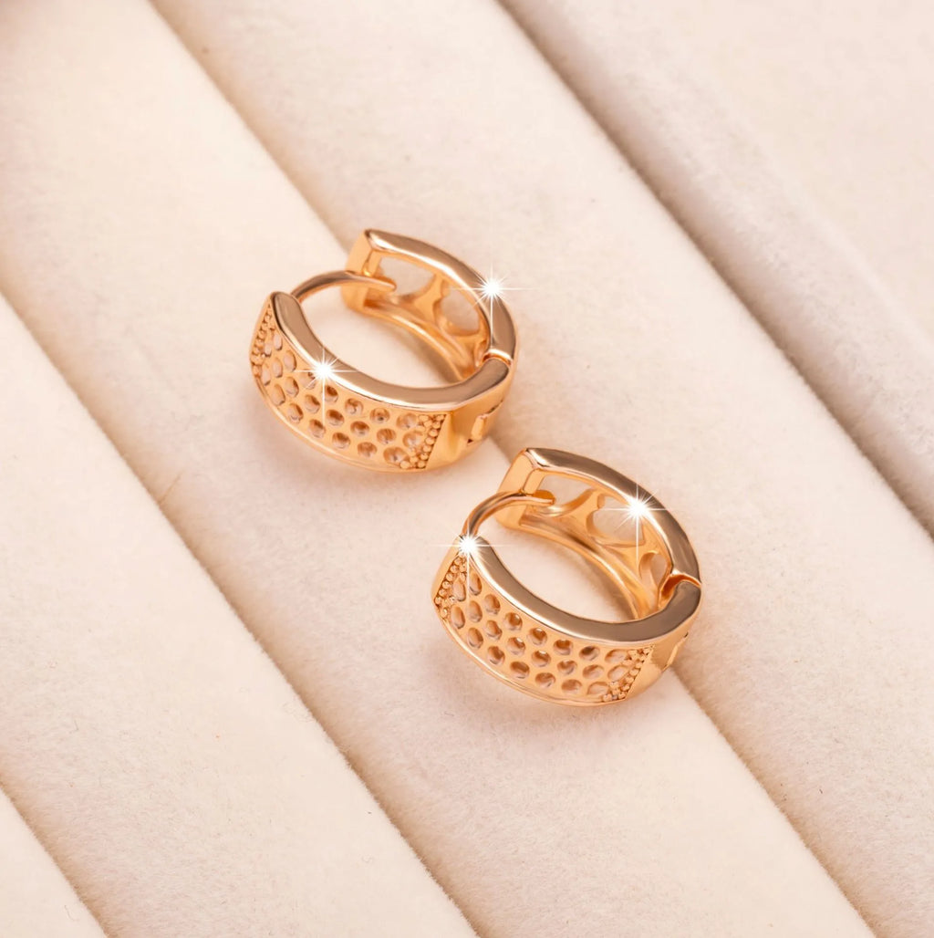 Rose gold electroplated earrings with three hollowed heart designs in circular shape