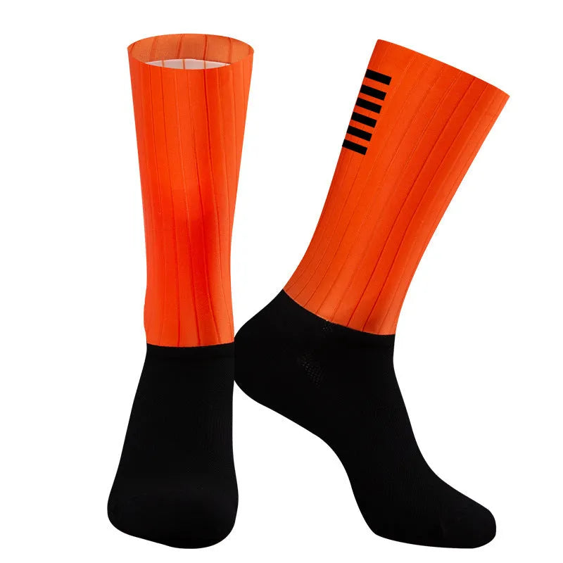 Athletic sports socks for cycling and running in six colour options including orange, black, and purple.