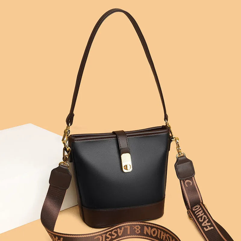 Black PU leather bucket bag with double shoulder straps showing internal compartments and external pocket