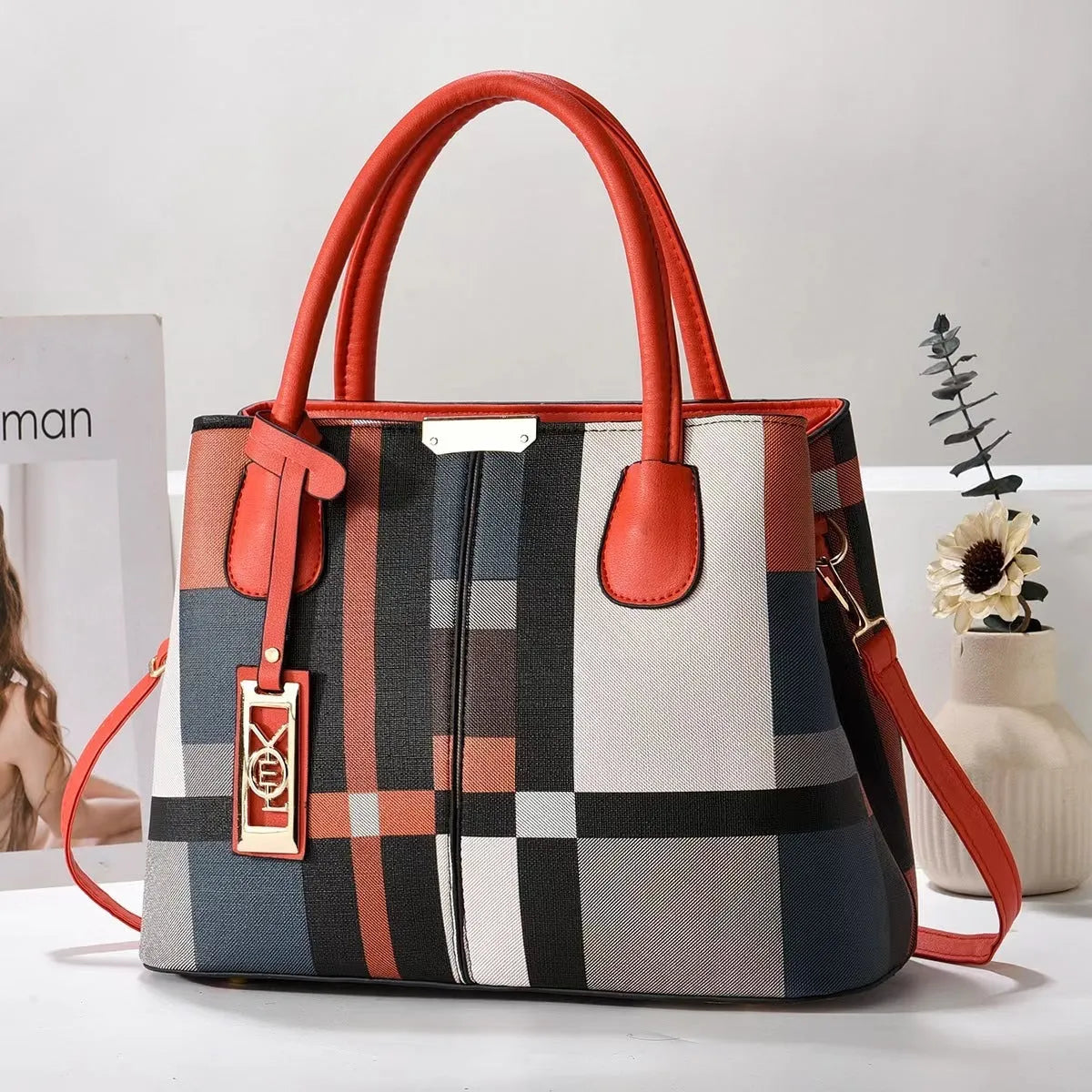 Soft large capacity PU leather shoulder bag in a horizontal square shape with a leather strap.