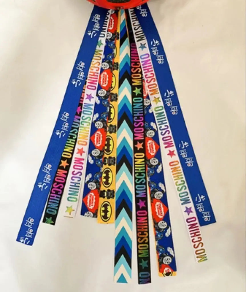 Decorative ribbon streamer for a child's ski or skating helmet in various colour options.
