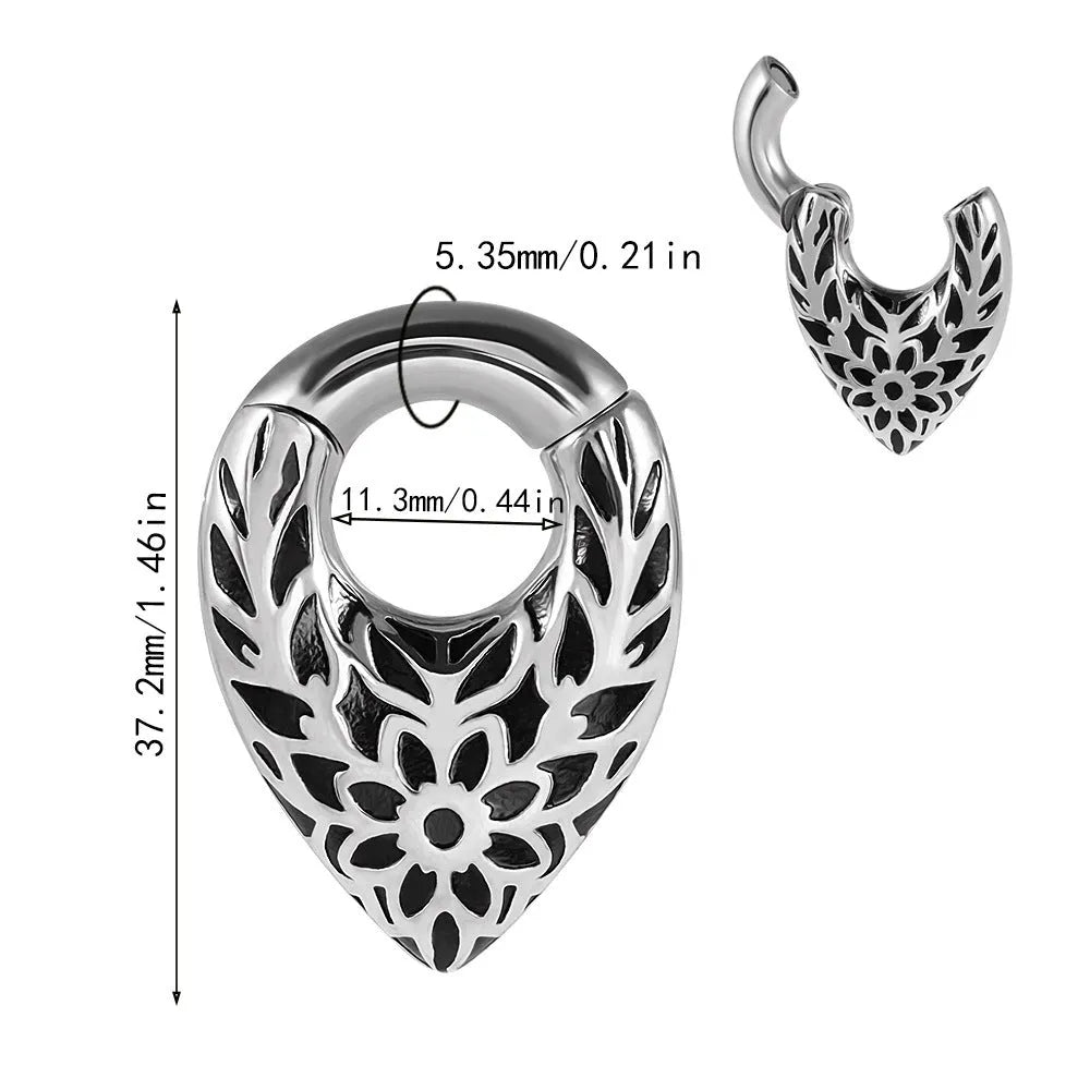 Stainless steel drop-shaped ear extender with totem design on a grey background.