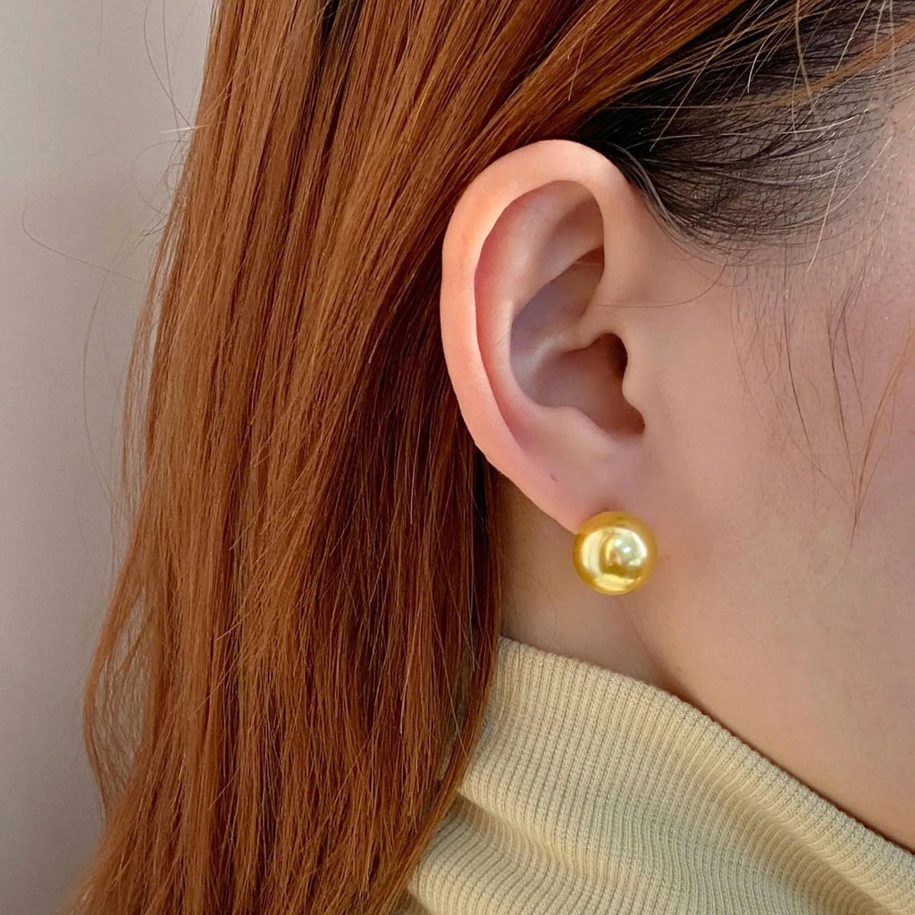 Large retro-style pearl stud earrings for women with a geometric eight-pointed star setting.