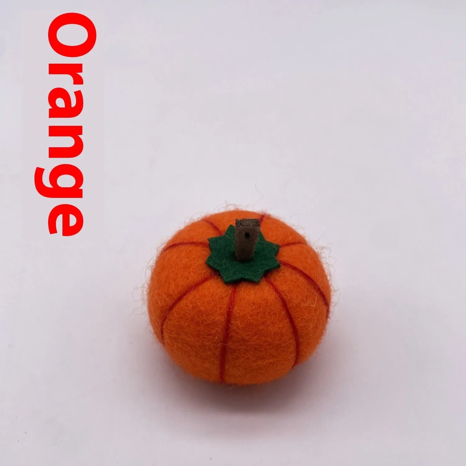Wool felt pumpkin ornament measuring 5cm diameter in autumn colours for miniature displays
