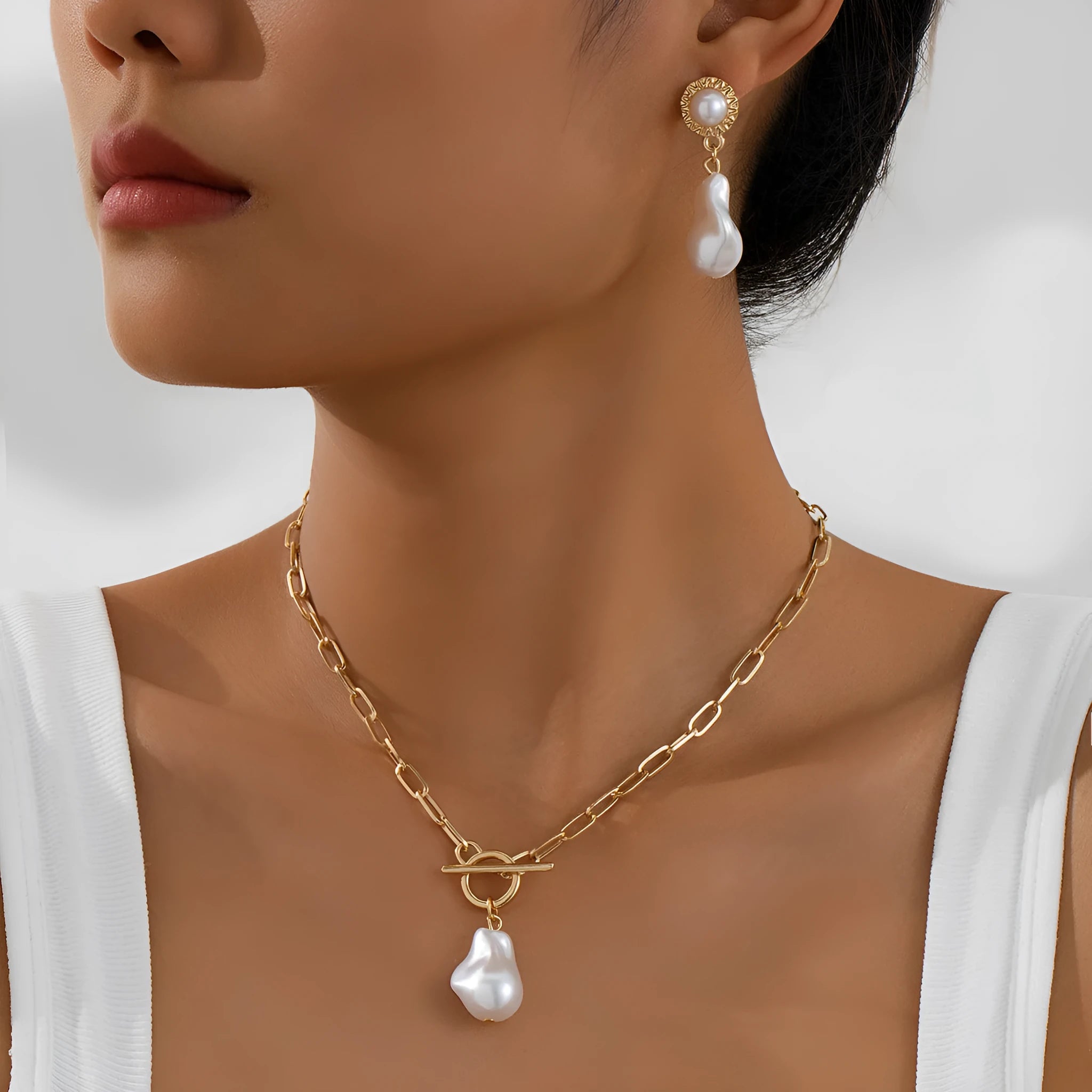 Gold tone retro baroque pearl pendant necklace and matching stud earrings set for women.