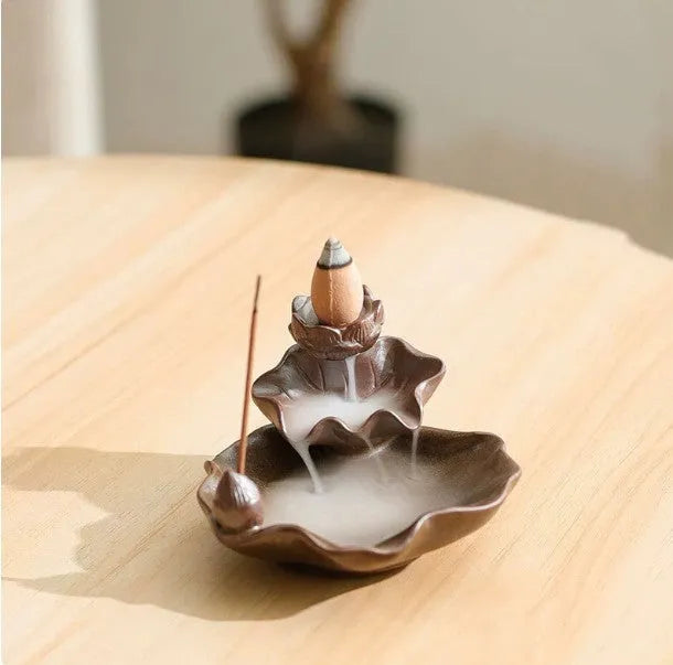 Purple clay ceramic reverse flow incense burner with lotus and plum blossom motifs