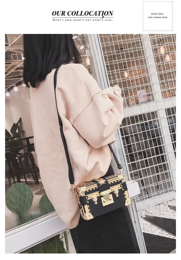 Hard-sided black PU leather women's shoulder bag with flap and decorative rivets.